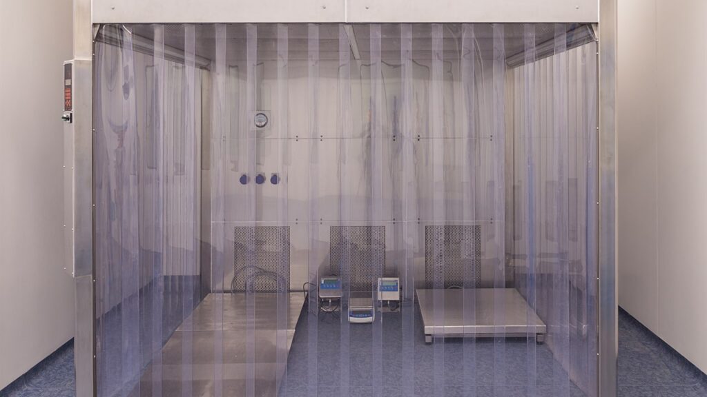 Stock photo of a clean room doorway with clear PVC strip curtains