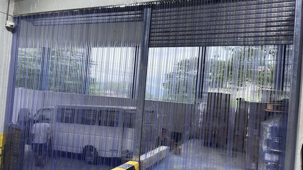 PVCPH photo of clear PVC strip curtains mounted across an industrial doorway