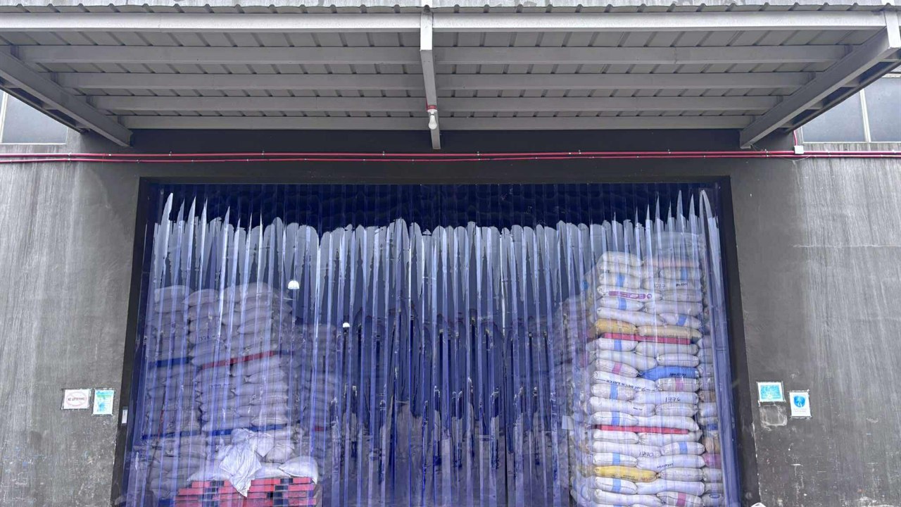PVCPH photo of blue clear PVC strip curtains across a warehouse doorway